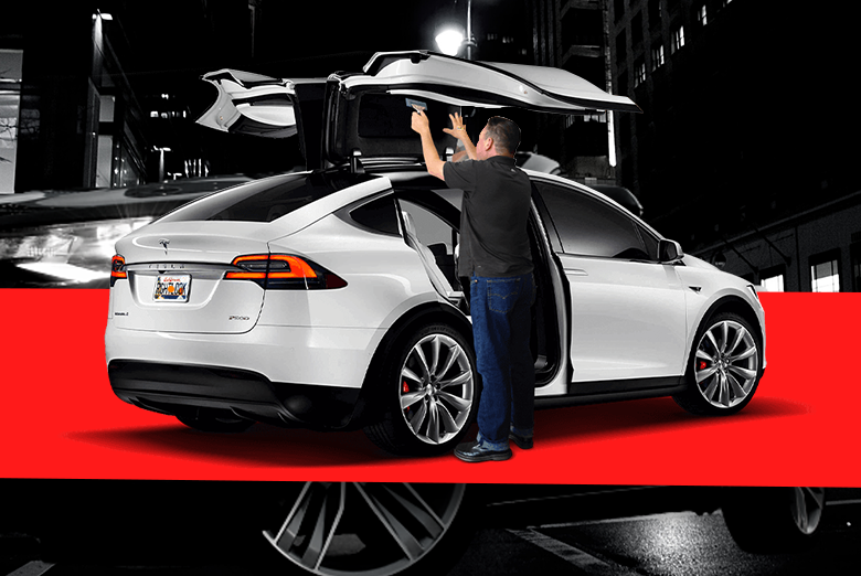 Automotive window tint installation on a white car